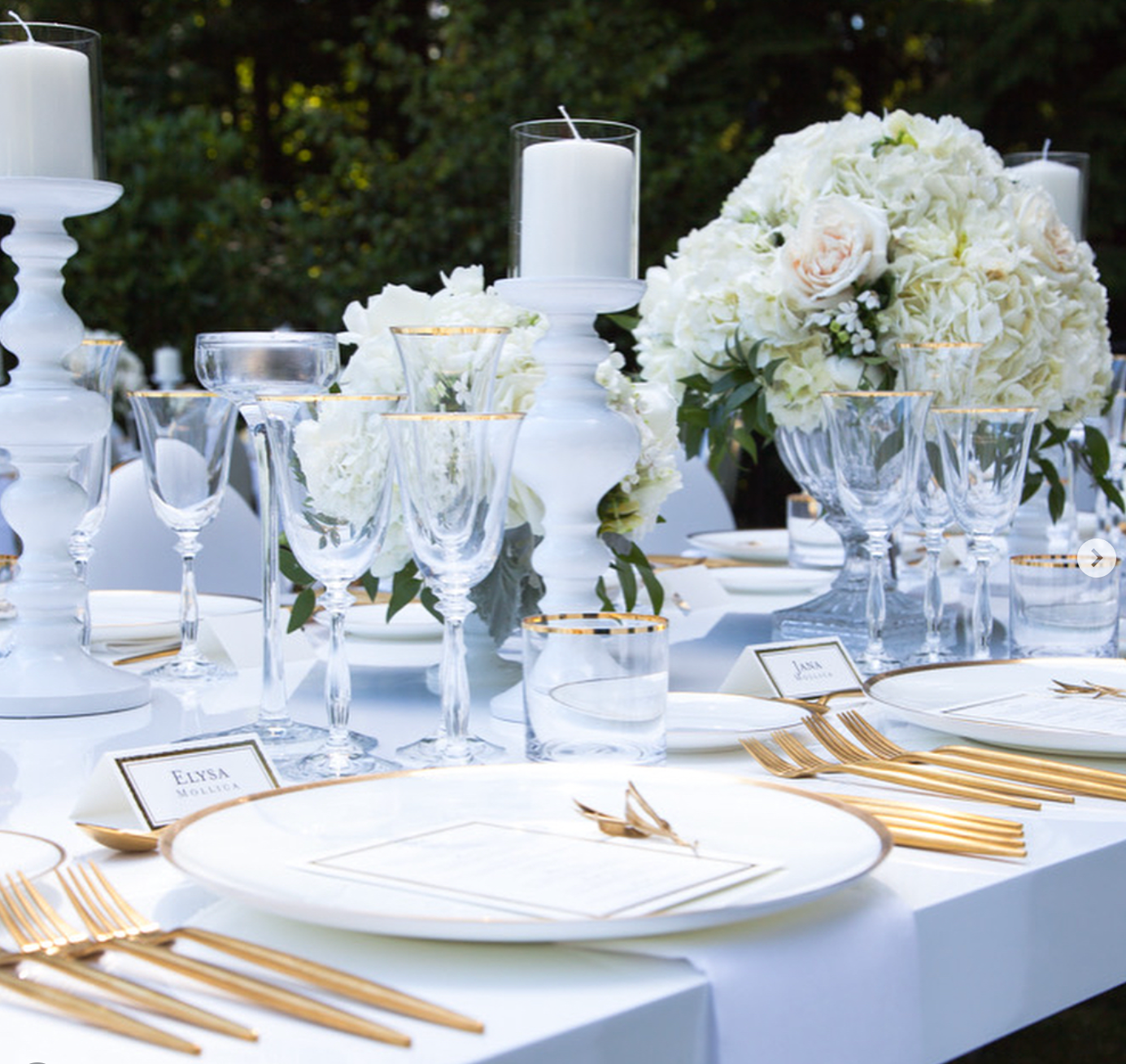 Brushed Gold Coupe Charger layered with white dinnerware, crystal stemware, gold flatware, and white floral centrepieces at a luxury outdoor wedding reception