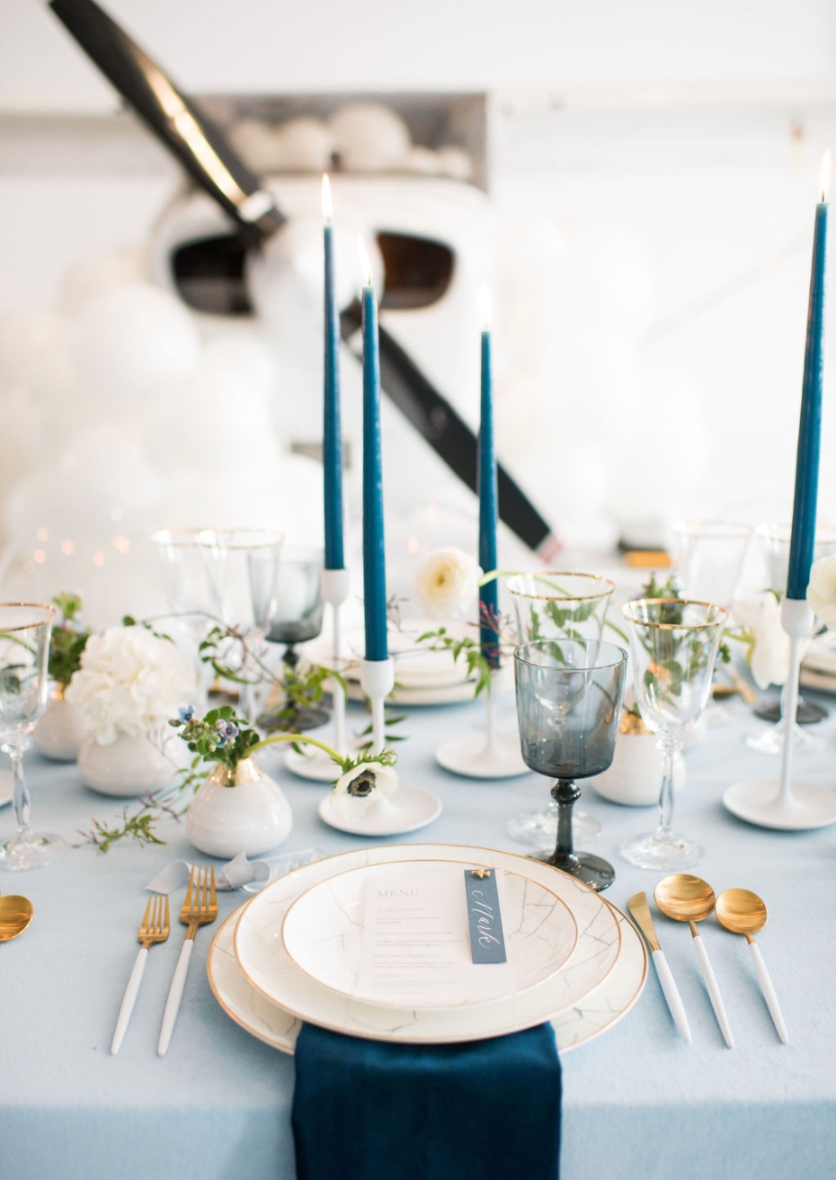 Carrara Marble Charger styled with crystal stemware, gold flatware, white florals, and modern wedding décor.