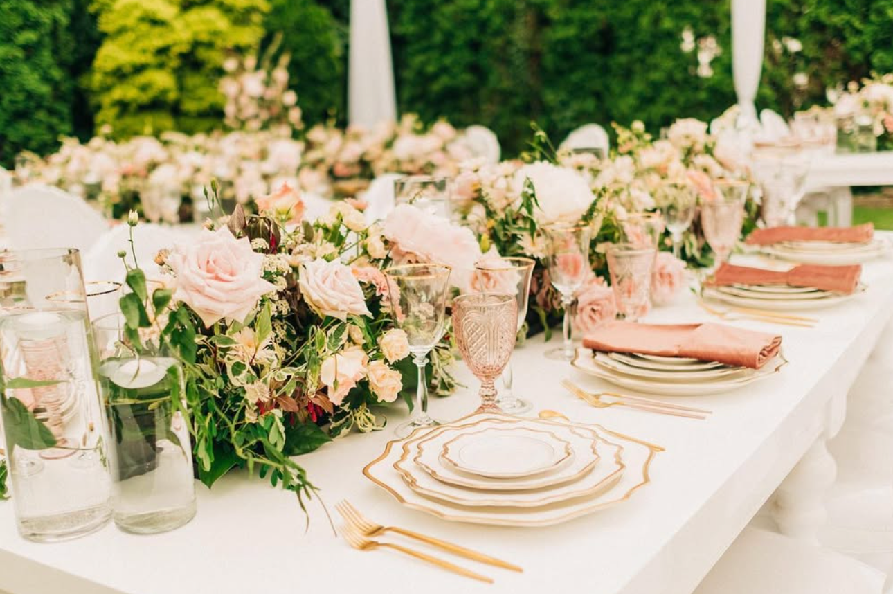 Vintage blush goblets featured on an elegant estate wedding reception table