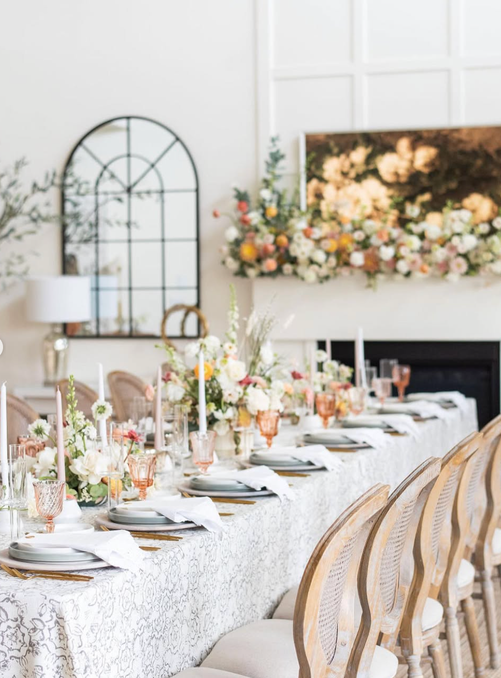 Vintage blush and pink goblets styled on an elegant wedding reception table with romantic florals